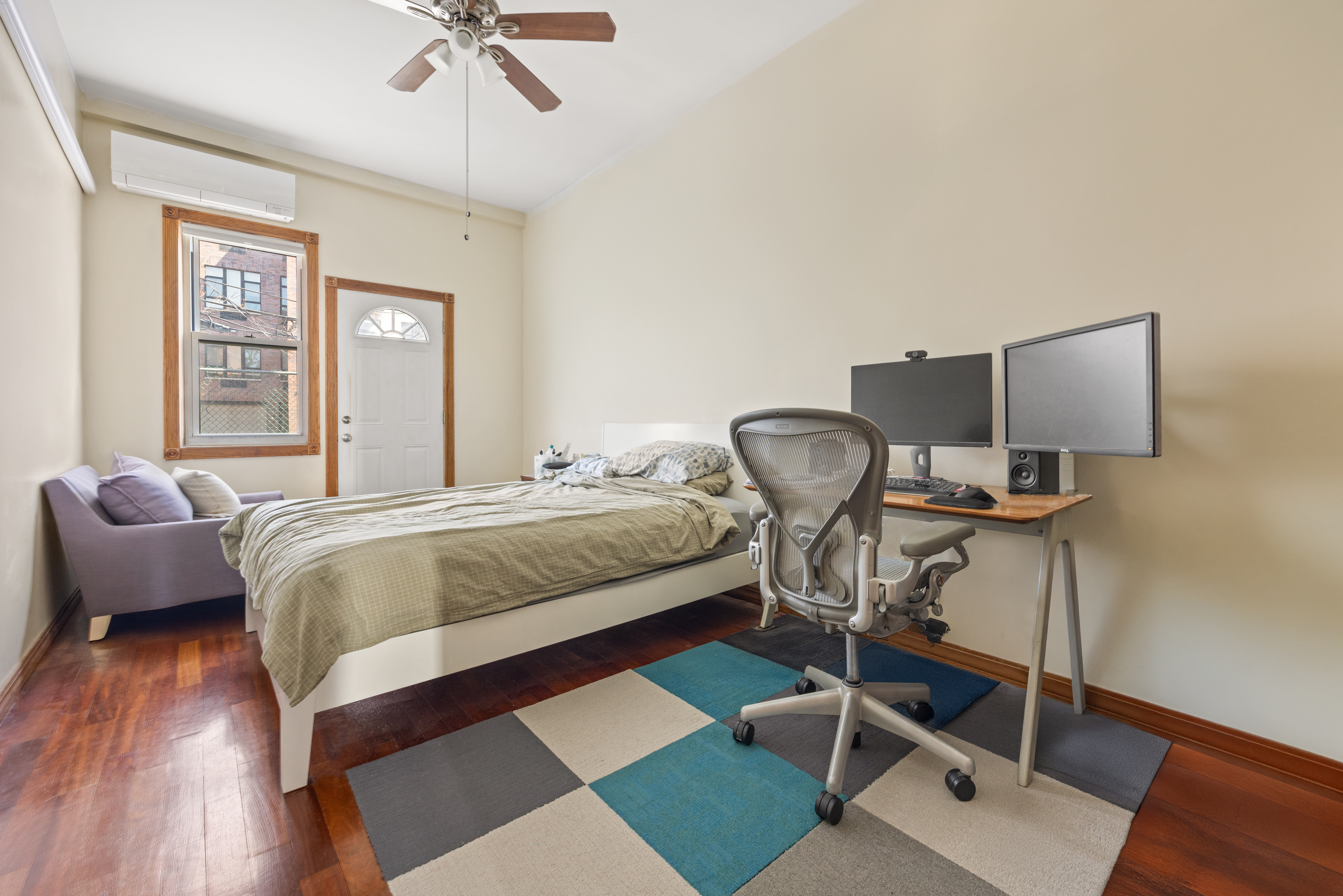 219 16th Street, Unit 1 Brooklyn, NY 11215 - Photo 4 of 7 a bedroom with a bed chairs and a window