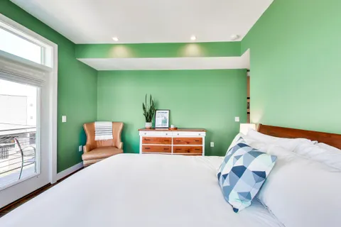 a bedroom with a bed and windows