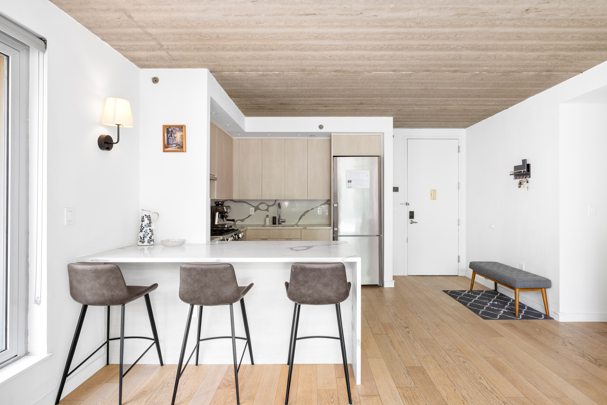 192 Spencer Street, Unit 3A Brooklyn, NY 11205 - Photo 5 of 12 a kitchen with stainless steel appliances kitchen island a chandelier