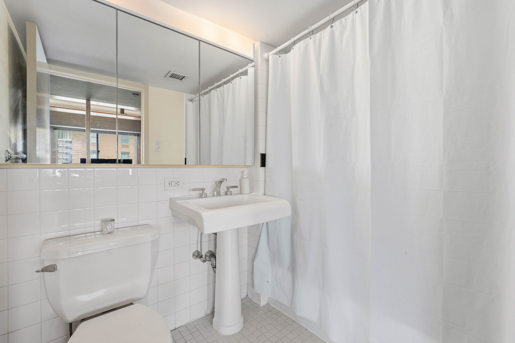 300 West 145th Street, Unit 6G Manhattan, NY 10039 - Photo 8 of 19 a bathroom with a sink a toilet and shower