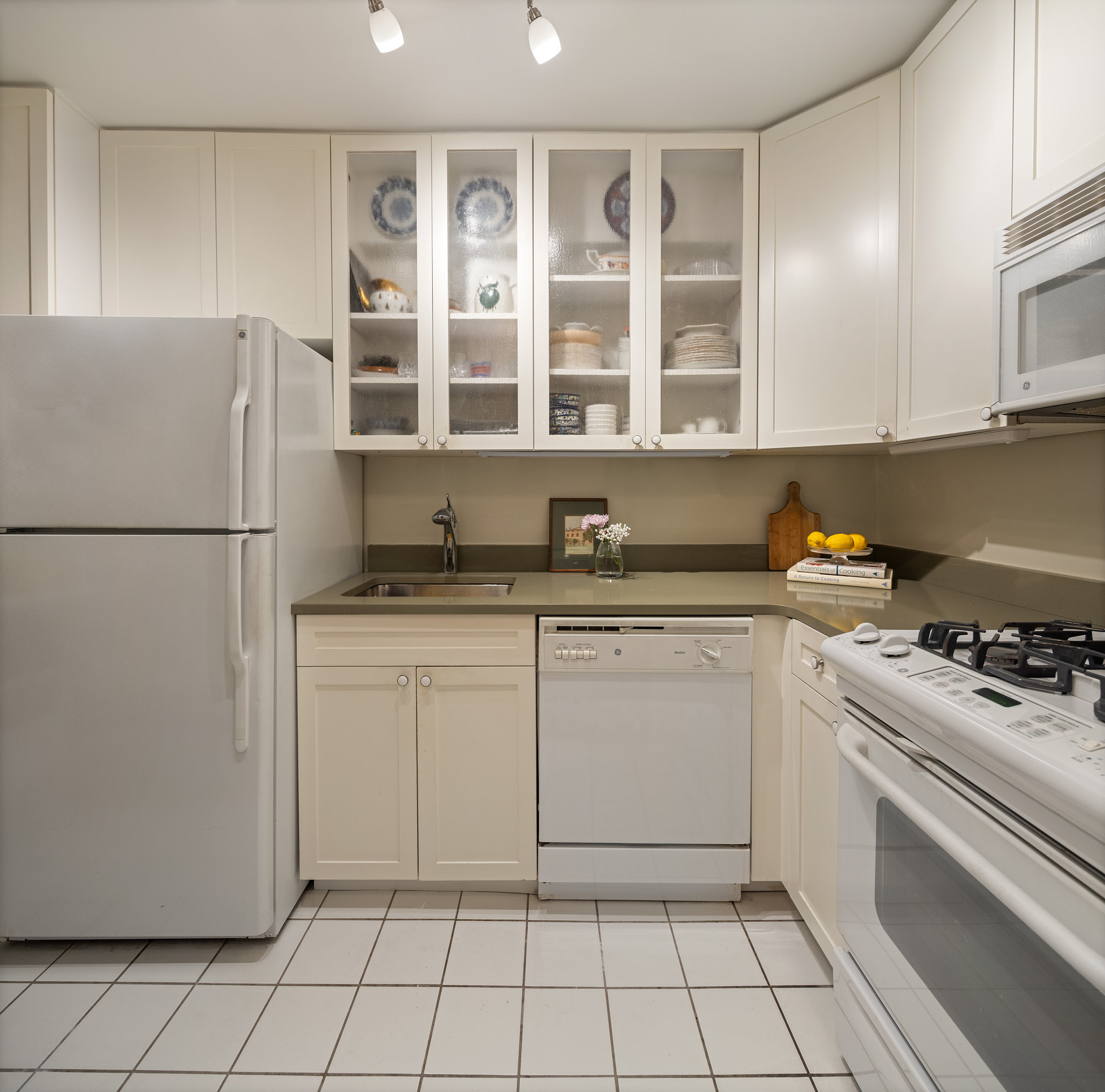 31 Jane Street, Unit 3H Manhattan, NY 10014 - Photo 4 of 14 a kitchen with a cabinets and a stove top oven