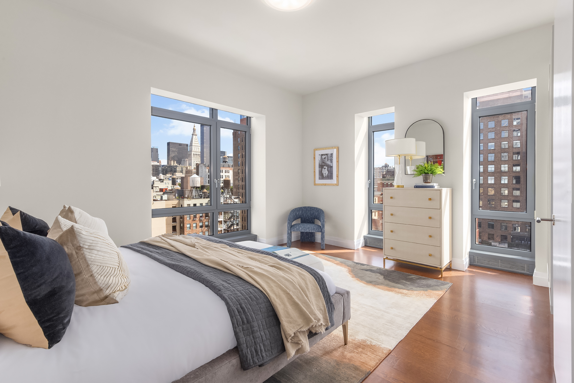 35 West 15th Street, Unit 15D Manhattan, NY 10011 - Photo 10 of 15 a bedroom with a large bed and a wooden floor