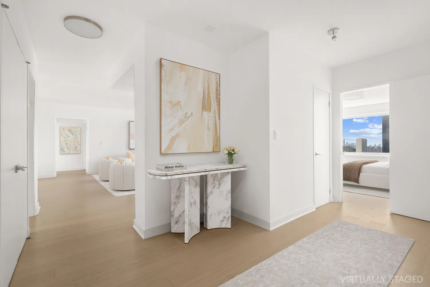 a living room with furniture a flat screen tv and a table