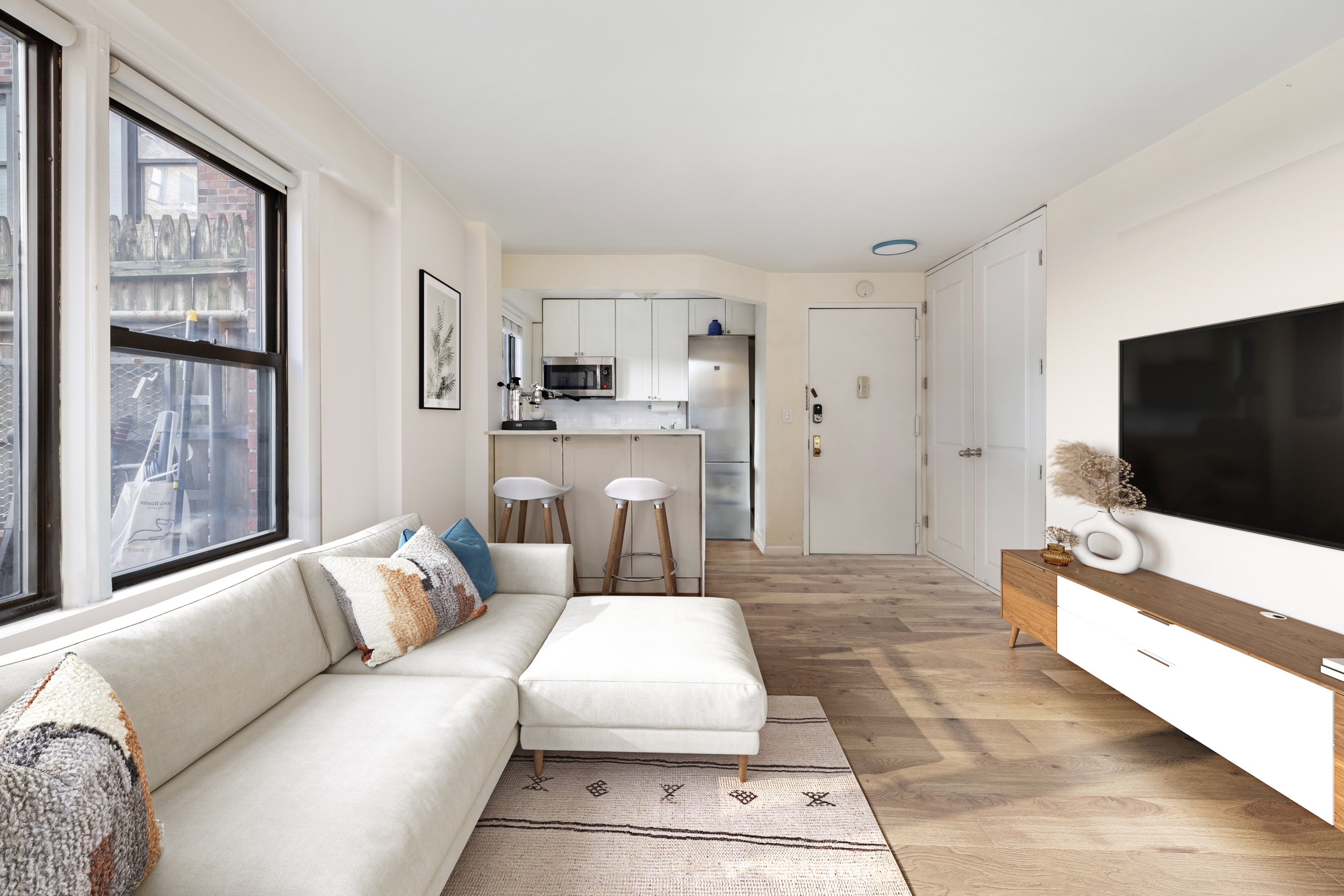 245 East 24th Street, Unit 2L Manhattan, NY 10010 - Photo 4 of 8 a living room with furniture and a flat screen tv