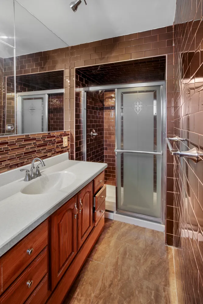 a spacious bathroom with a granite countertop sink and a mirror
