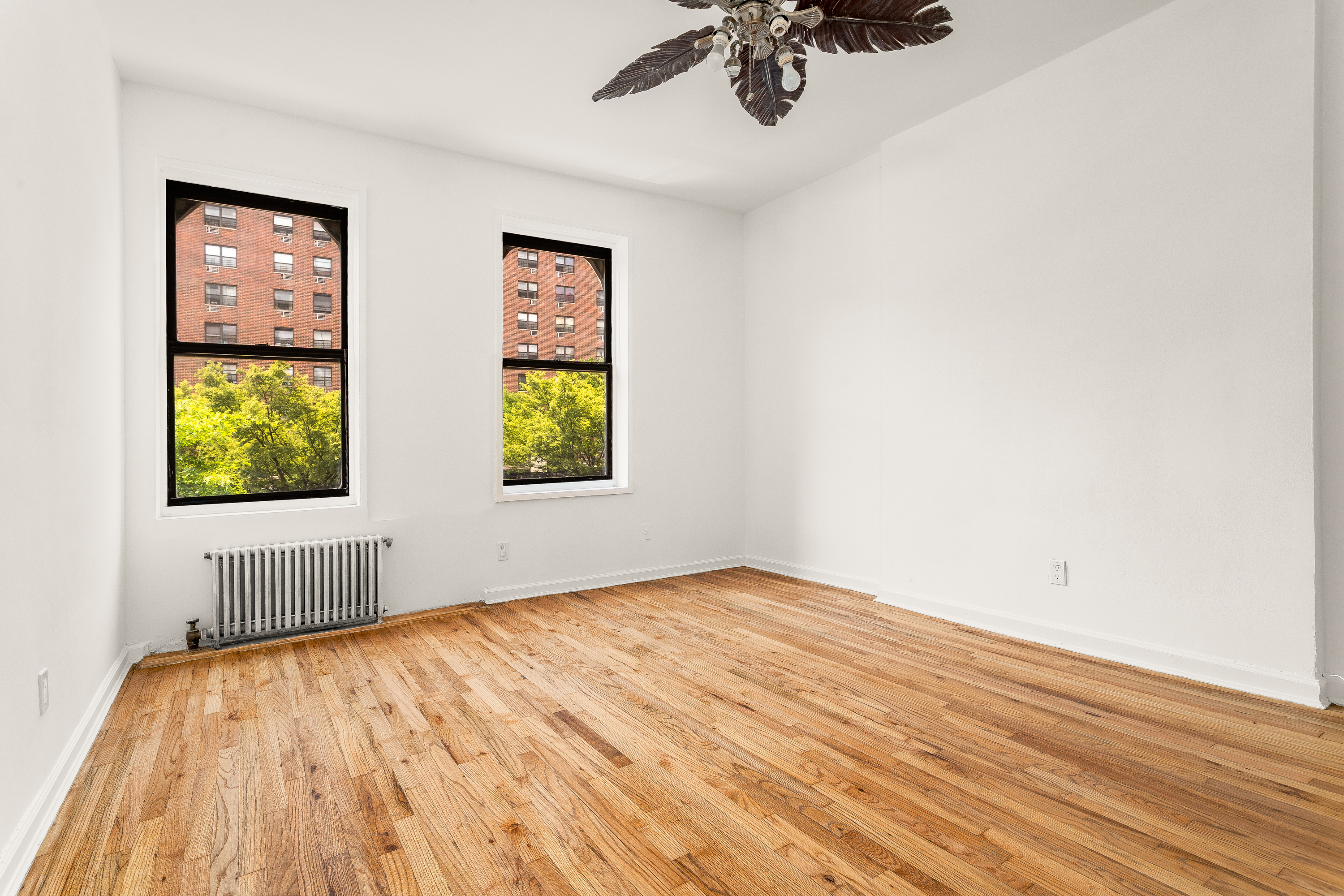 157 West 123rd Street, Unit 2A Manhattan, NY 10027 - Photo 2 of 16 an empty room with a window