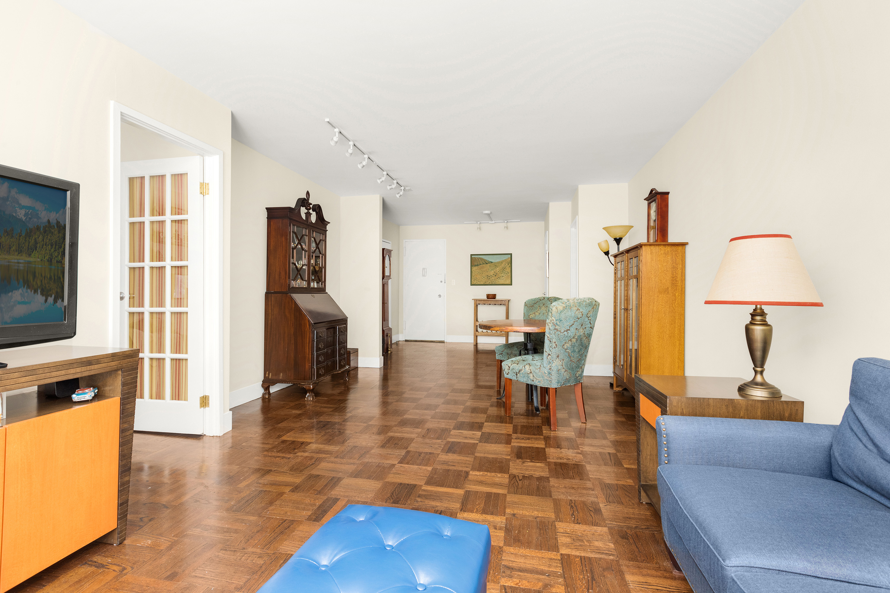 525 East 86th Street, Unit 2G Manhattan, NY 10028 - Photo 3 of 12 a living room with furniture a flat screen tv and a table