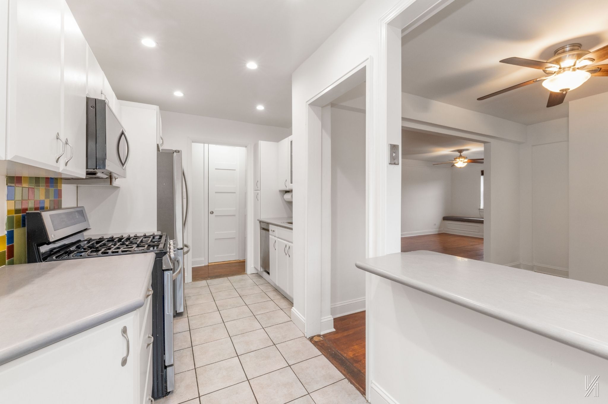 34-10 94th Street, Unit 6G Queens, NY 11372 - Photo 7 of 19 a kitchen with stainless steel appliances a refrigerator sink and cabinets