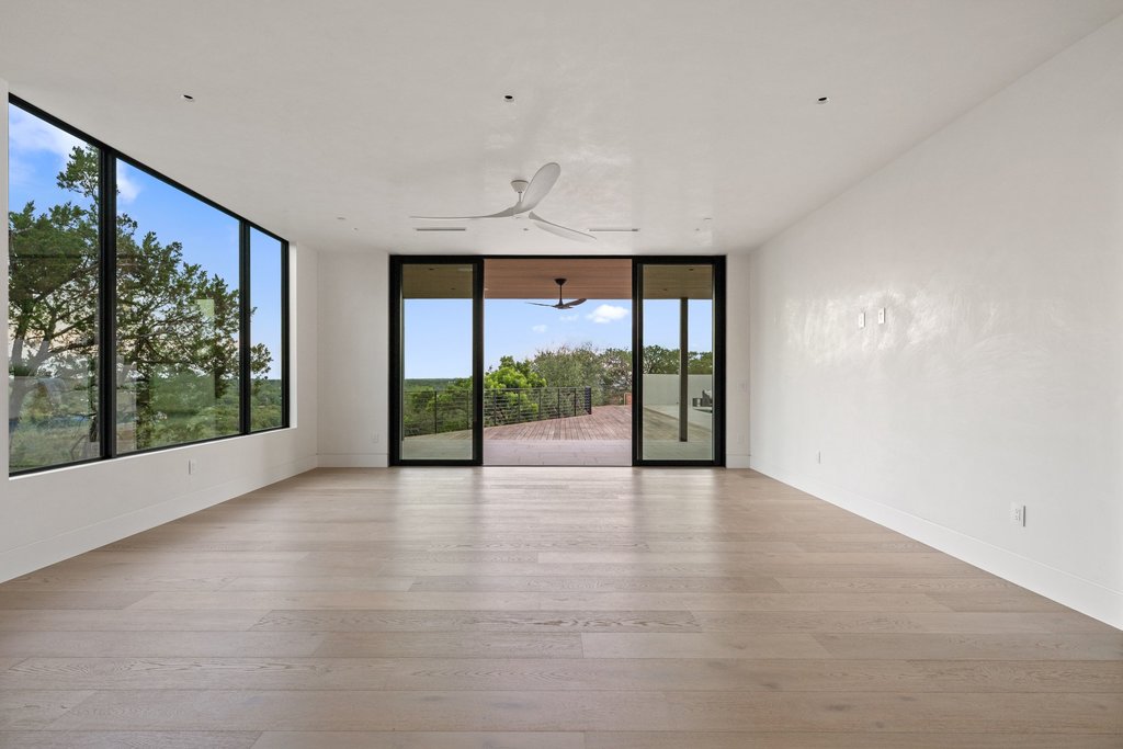 Mt Bonnell Road Austin, TX 78731 - Photo 34 of 51 a view of an empty room with wooden floor and a floor to ceiling window