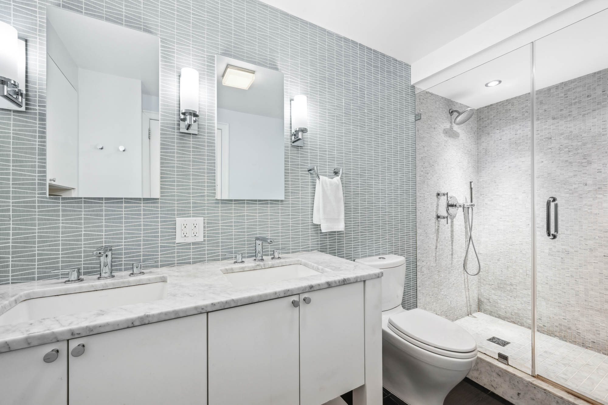 420 East 72nd Street, Unit 2J Manhattan, NY 10021 - Photo 7 of 12 a bathroom with a sink toilet and shower
