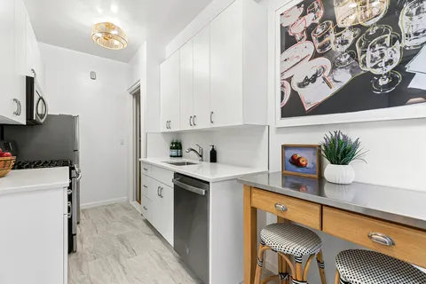 a kitchen with stainless steel appliances a stove a sink and a refrigerator