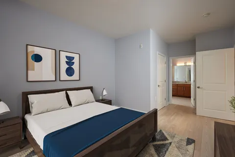 a bedroom with a bed and painting on the wall