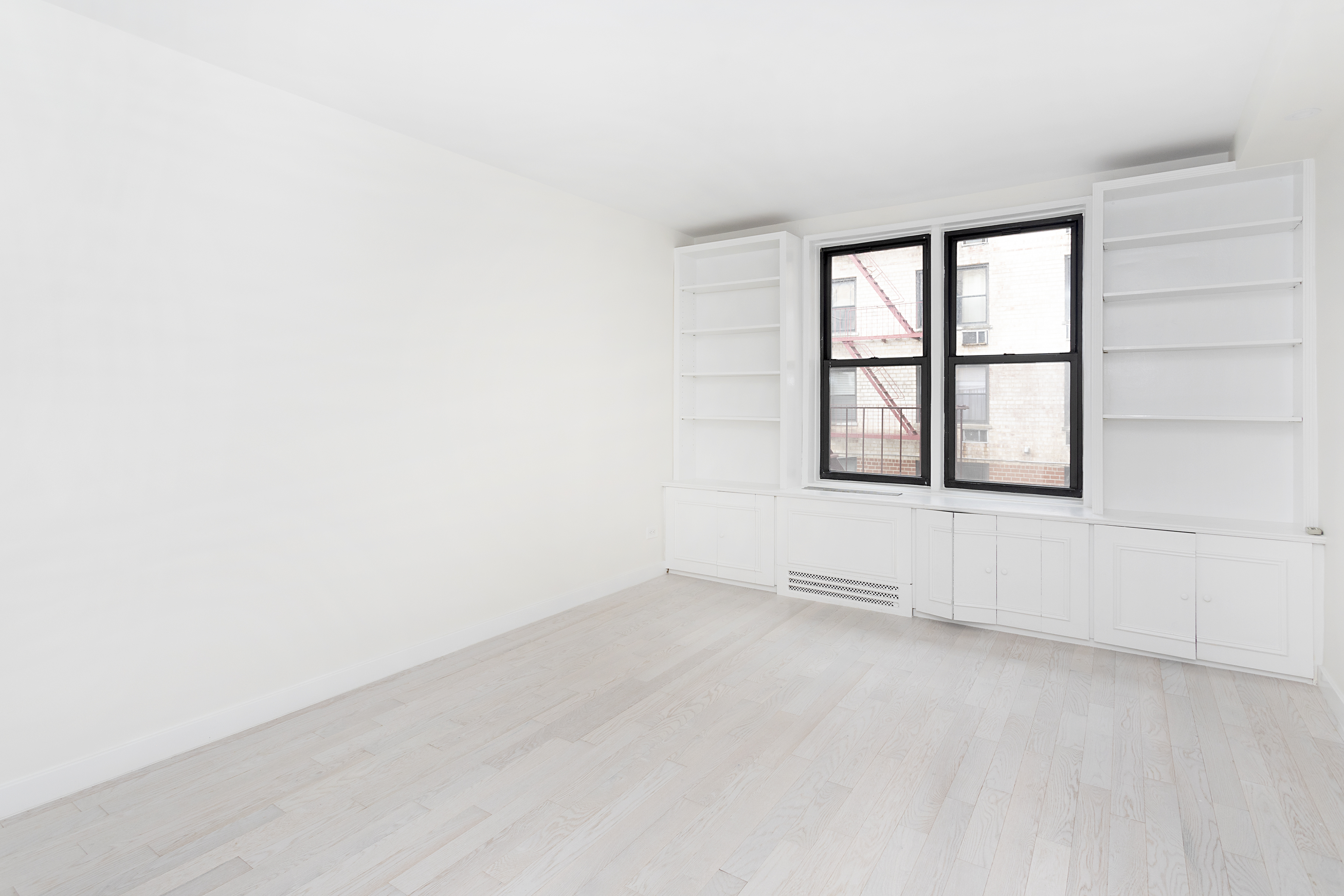 165 Christopher Street, Unit 1C Manhattan, NY 10014 - Photo 6 of 10 an empty room with a window