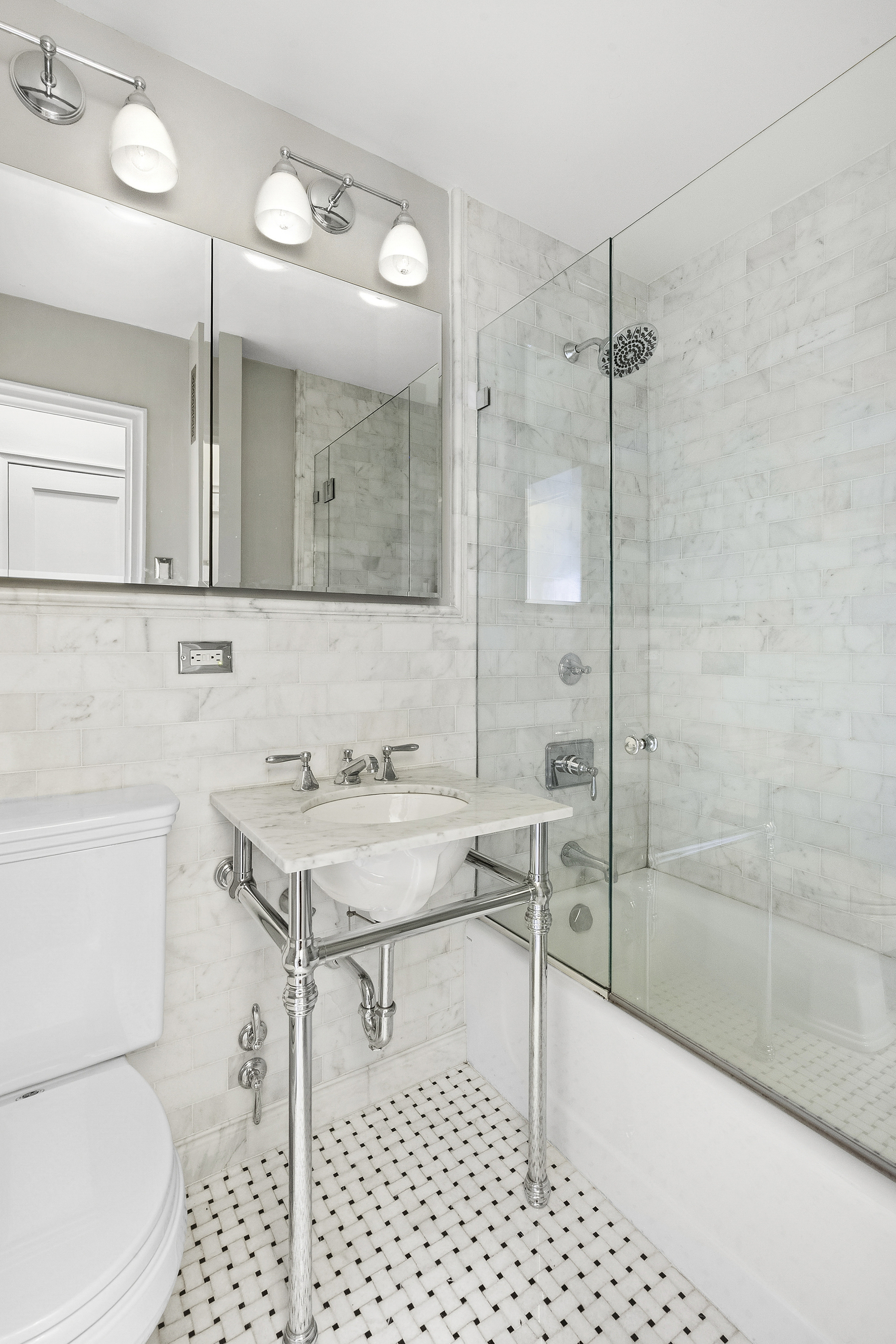263 West End Avenue, Unit 9E Manhattan, NY 10023 - Photo 5 of 10 a bathroom with a sink a toilet and shower