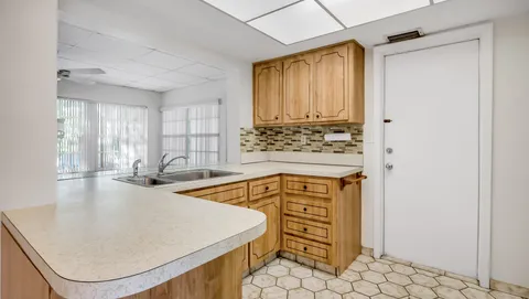 an open kitchen with a sink a stove and a refrigerator