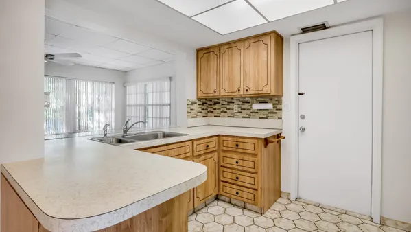 an open kitchen with a sink a stove and a refrigerator