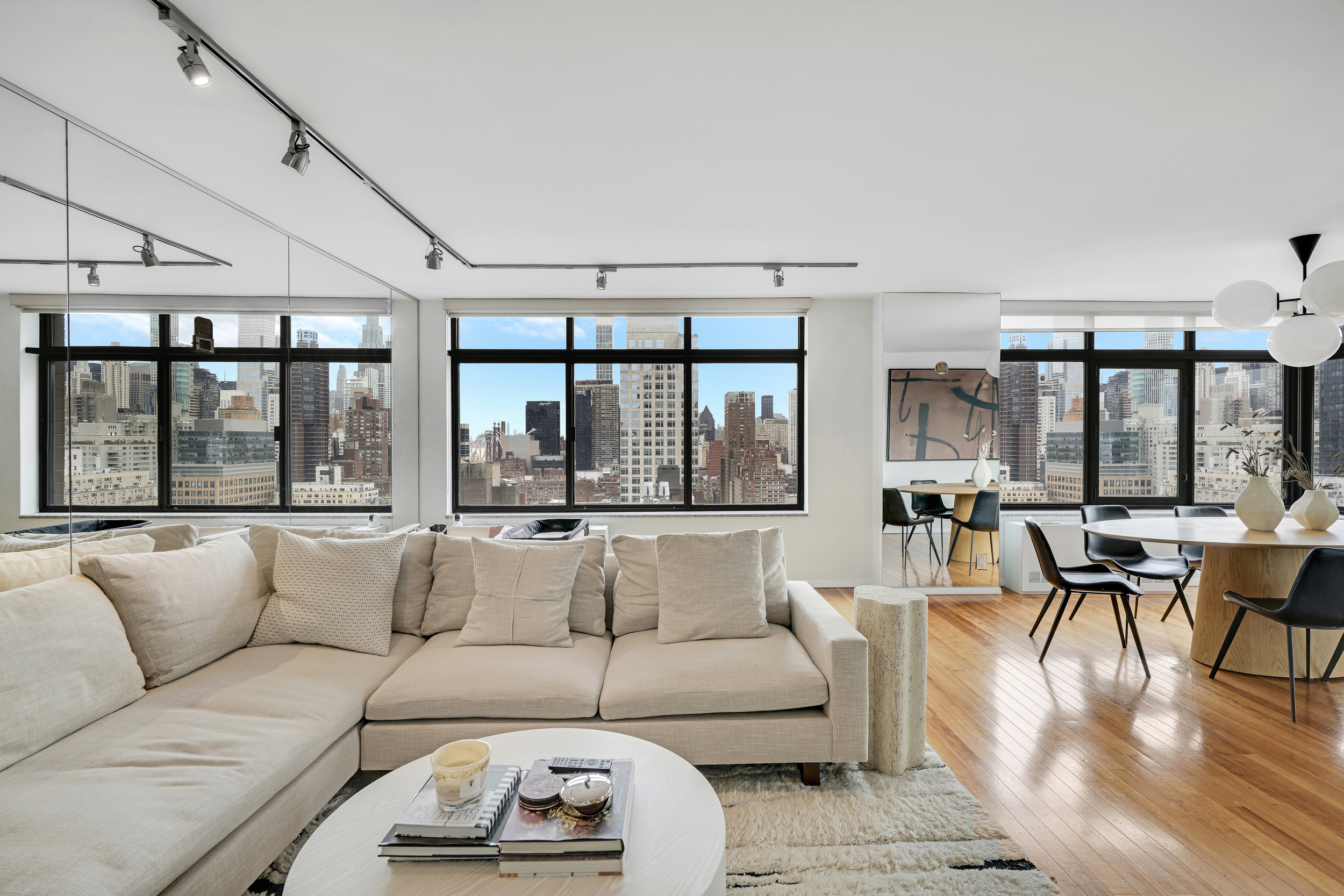 400 East 70th Street, Unit 2402 Manhattan, NY 10021 - Photo 2 of 18 a living room with furniture and large windows