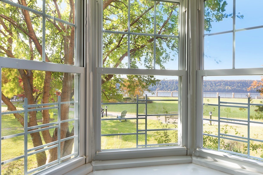 a view of a glass door with a tree