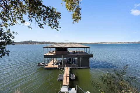 a view of a big yard with swimming pool and green space