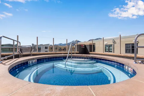 a view of a swimming pool with outdoor seating