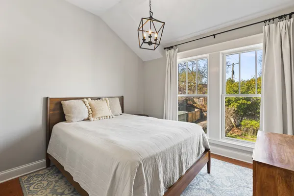 a bedroom with a large bed and a window