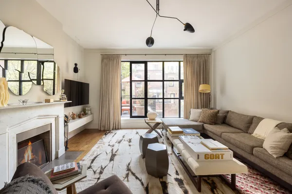 a living room with furniture a flat screen tv and a fireplace