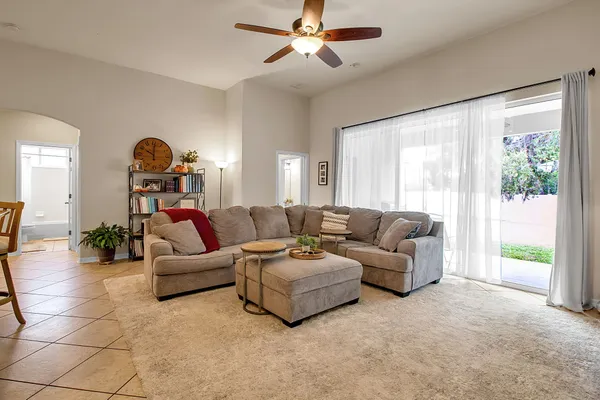a view of a livingroom with workspace and a window