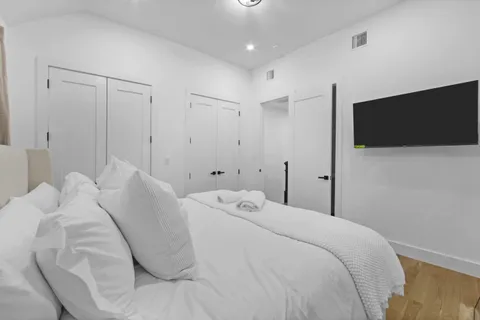 a bedroom with a bed and a flat screen tv