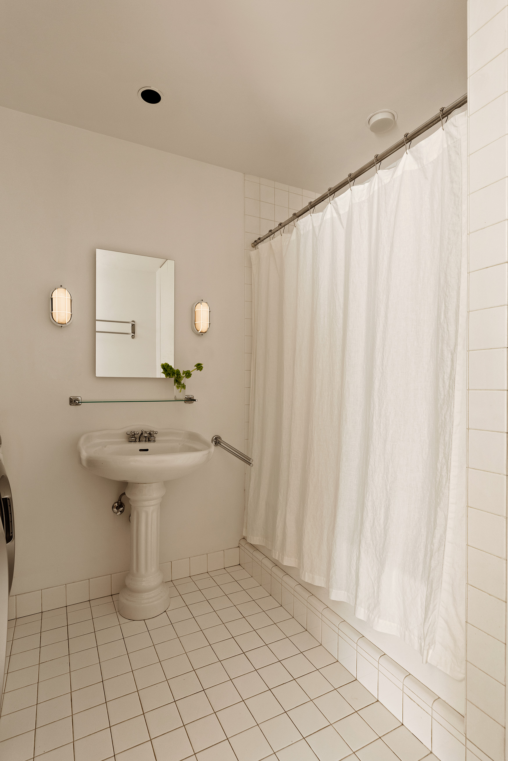32 West 20th Street, Unit 9B Manhattan, NY 10011 - Photo 15 of 16 a bathroom with a sink a mirror and a toilet