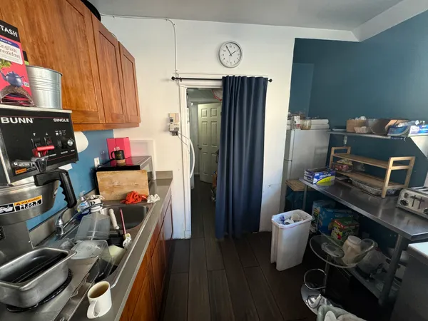 a kitchen with a refrigerator and a stove