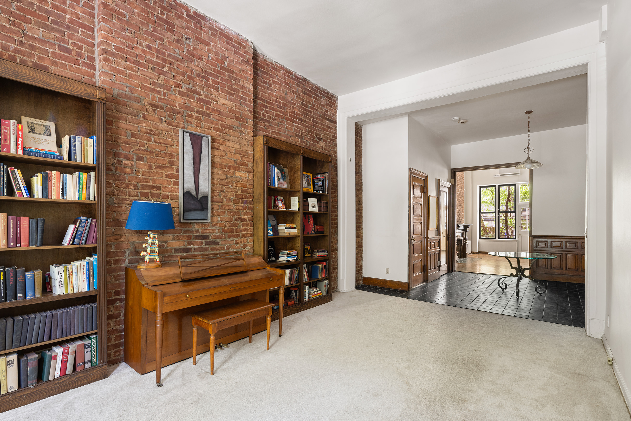 144 West 80th Street Manhattan, NY 10024 - Photo 5 of 22 a living room with furniture and a book shelf