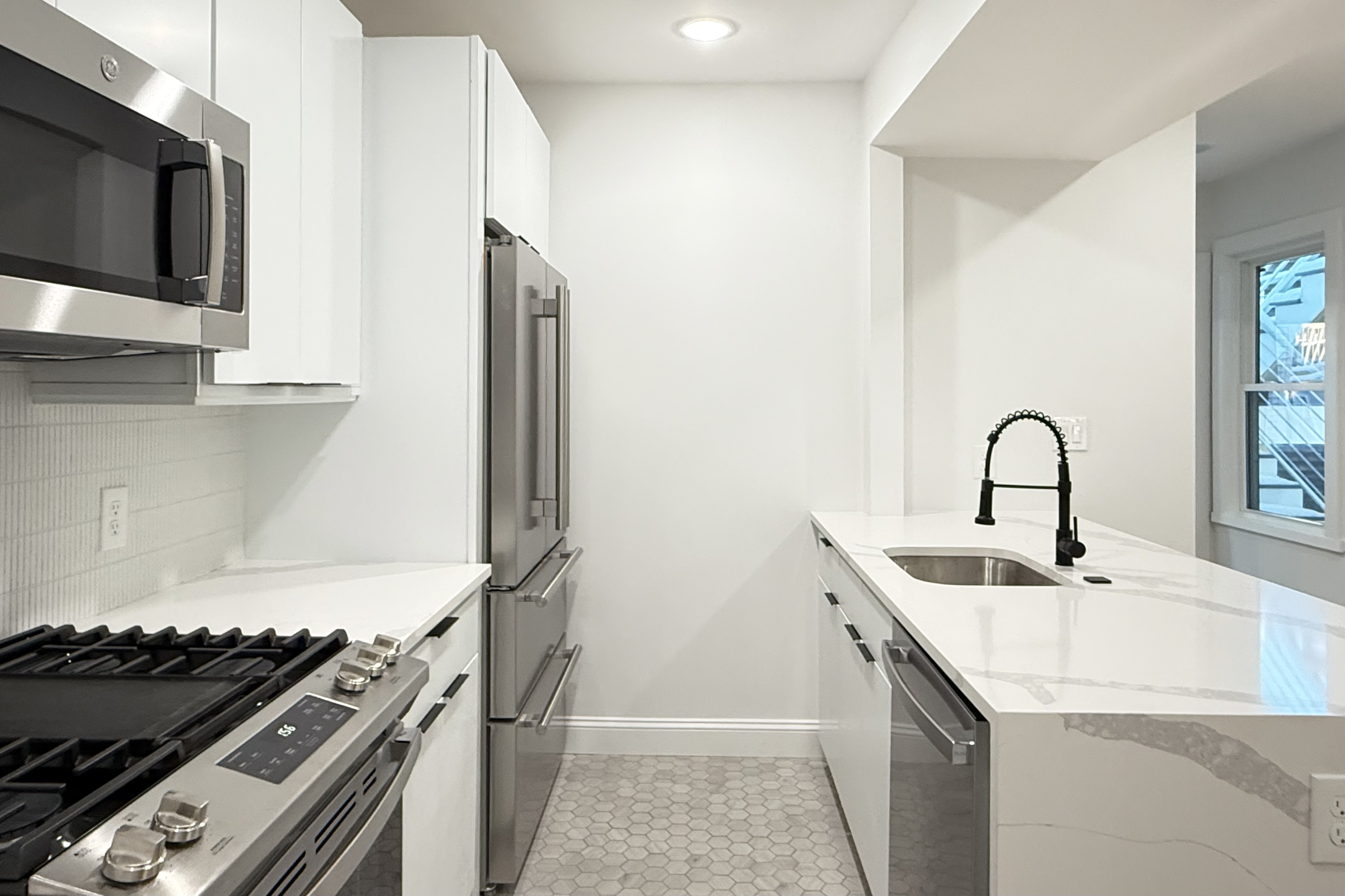 76 Webster Street East Boston, MA 02128 - Photo 2 of 8 a kitchen with a sink and a stove top oven with wooden floor