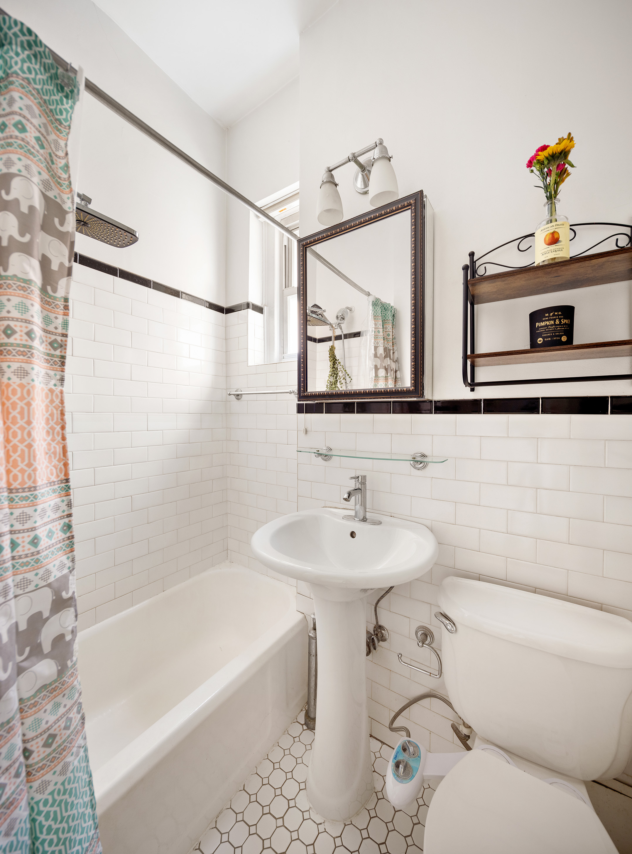 175 East 93rd Street, Unit 3B Manhattan, NY 10128 - Photo 9 of 12 a bathroom with a sink toilet and shower
