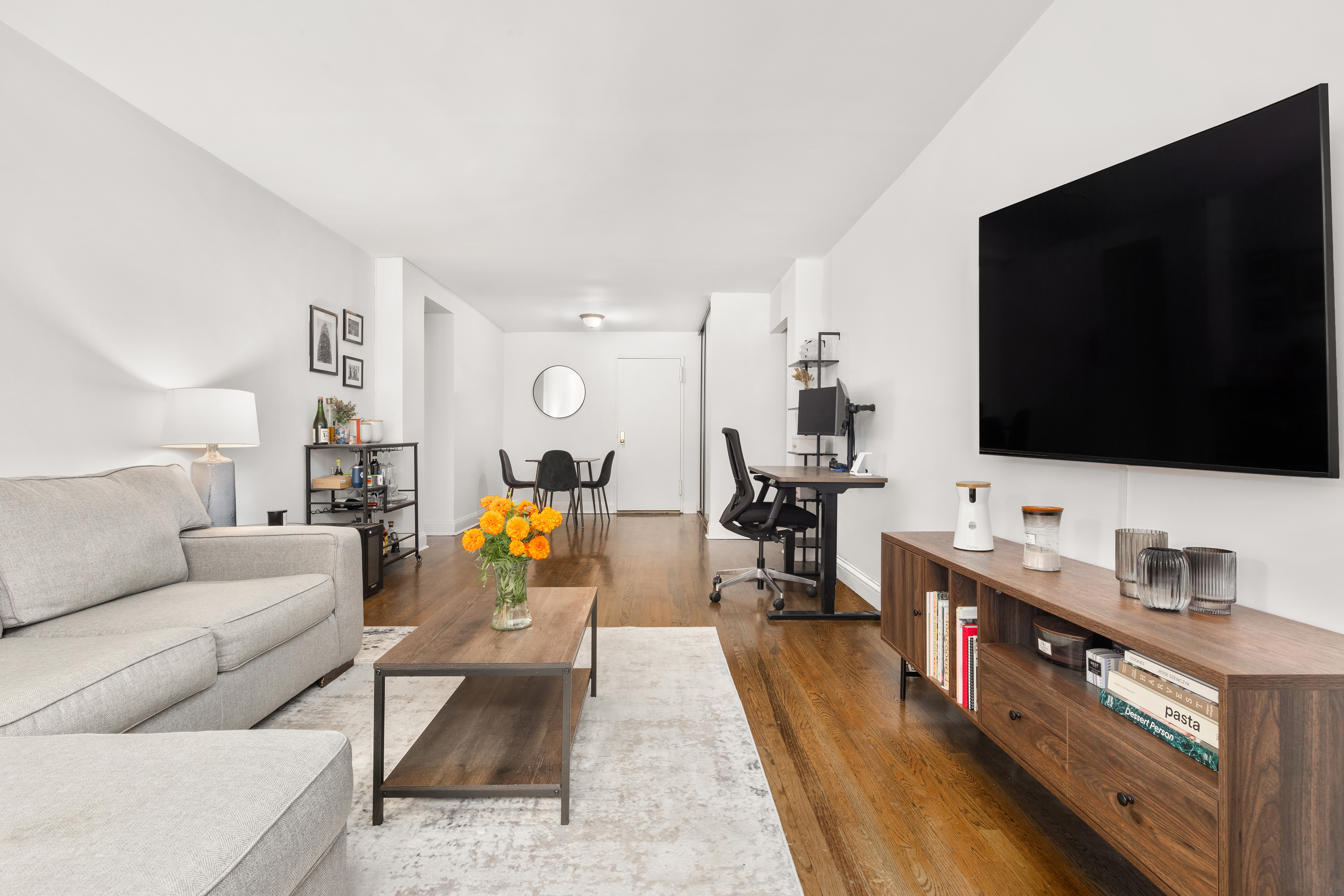 140 7th Avenue, Unit 4M Manhattan, NY 10011 - Photo 2 of 7 a living room with furniture and a flat screen tv