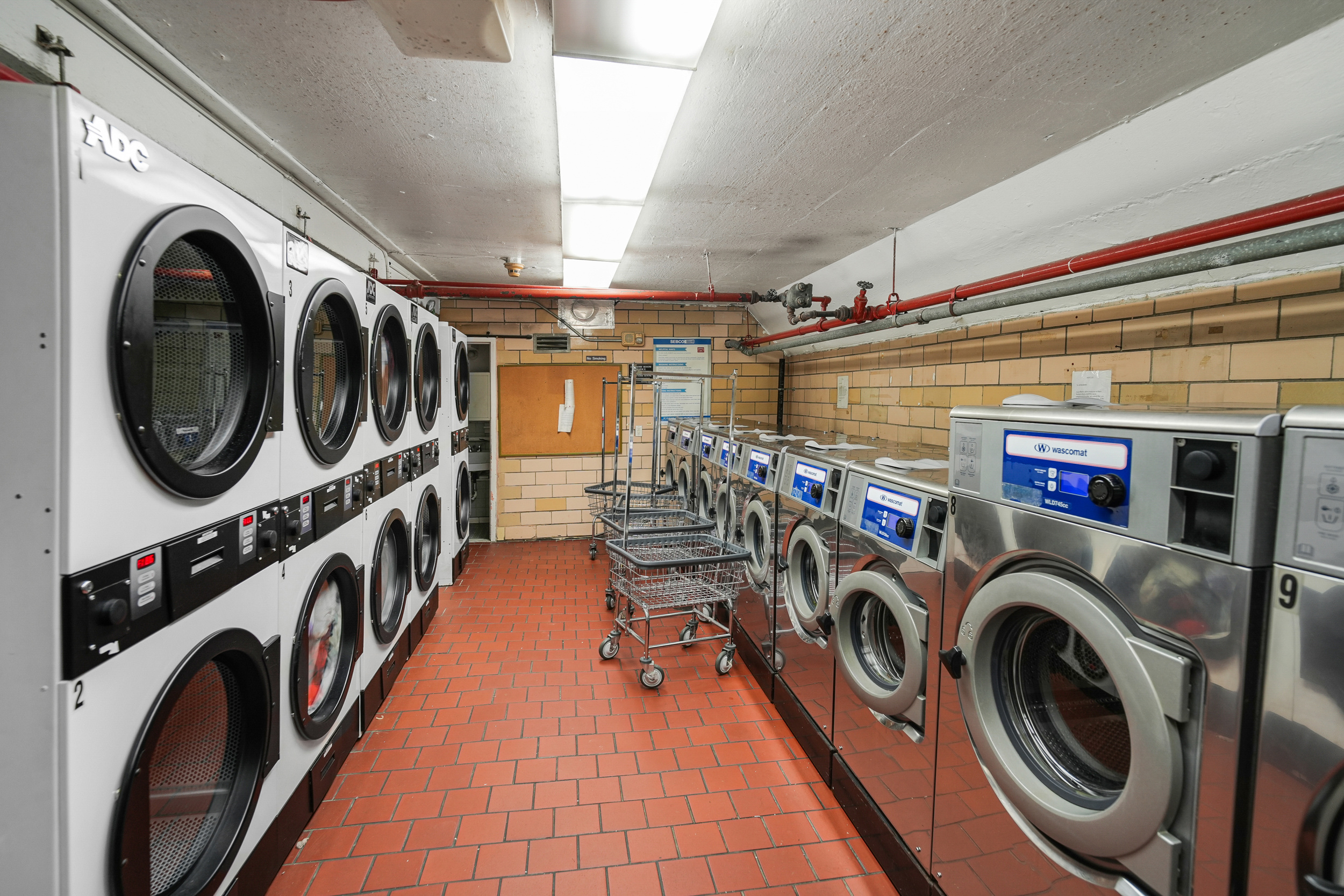 240 East 76th Street, Unit 10L Manhattan, NY 10021 - Photo 7 of 9 a view of a storage and utility room with washer and dryer