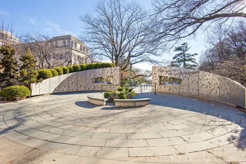 a view of white house with a yard covered with snow