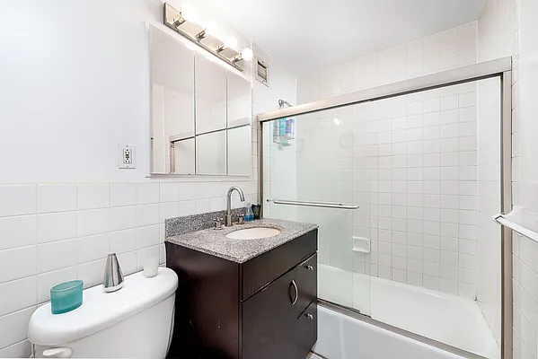 61 Lexington Avenue, Unit 4F Manhattan, NY 10010 - Photo 5 of 6 a bathroom with a sink toilet and shower