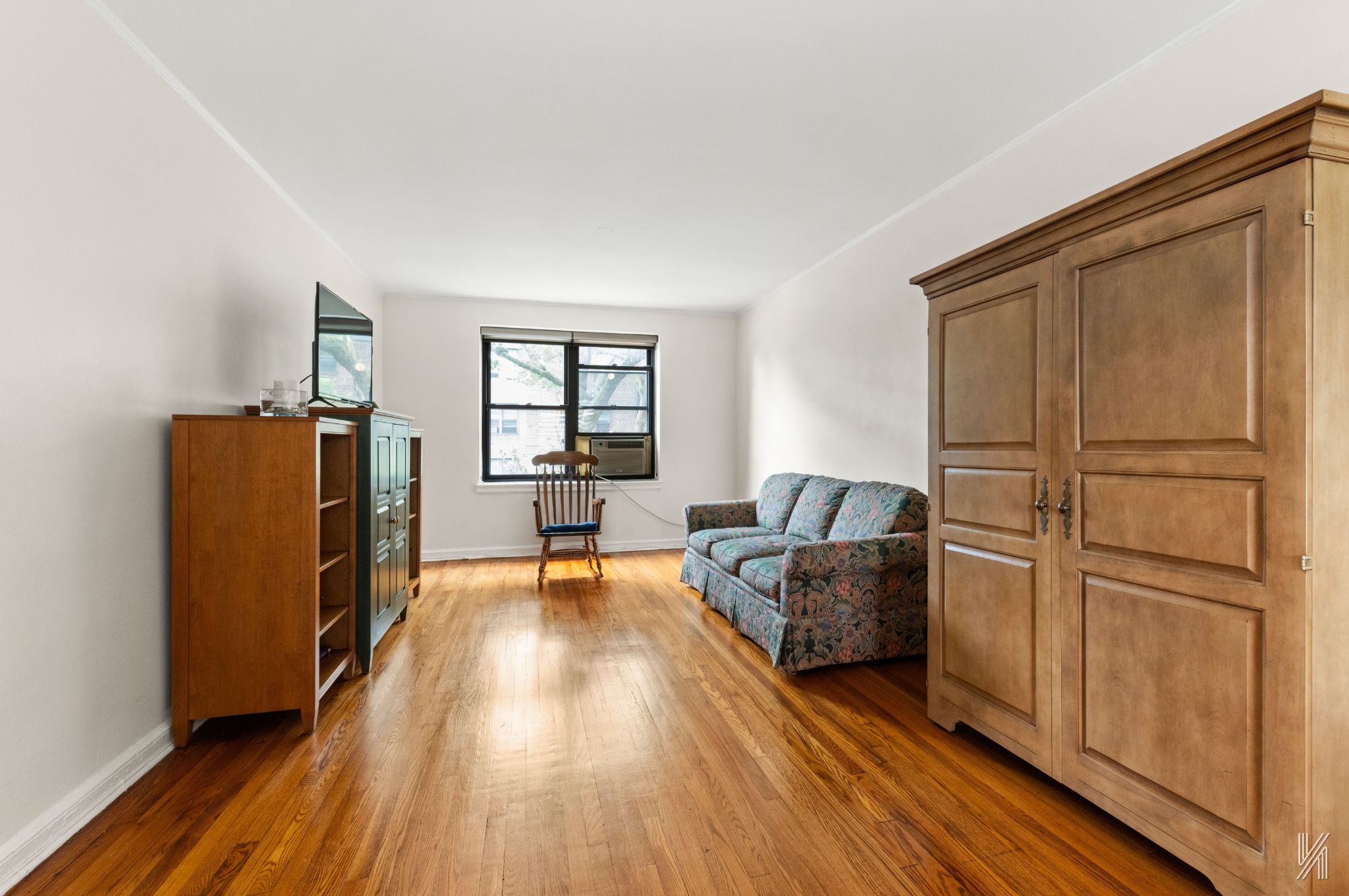 22-08 76th Street, Unit D2 Queens, NY 11370 - Photo 2 of 20 a living room with furniture and a window