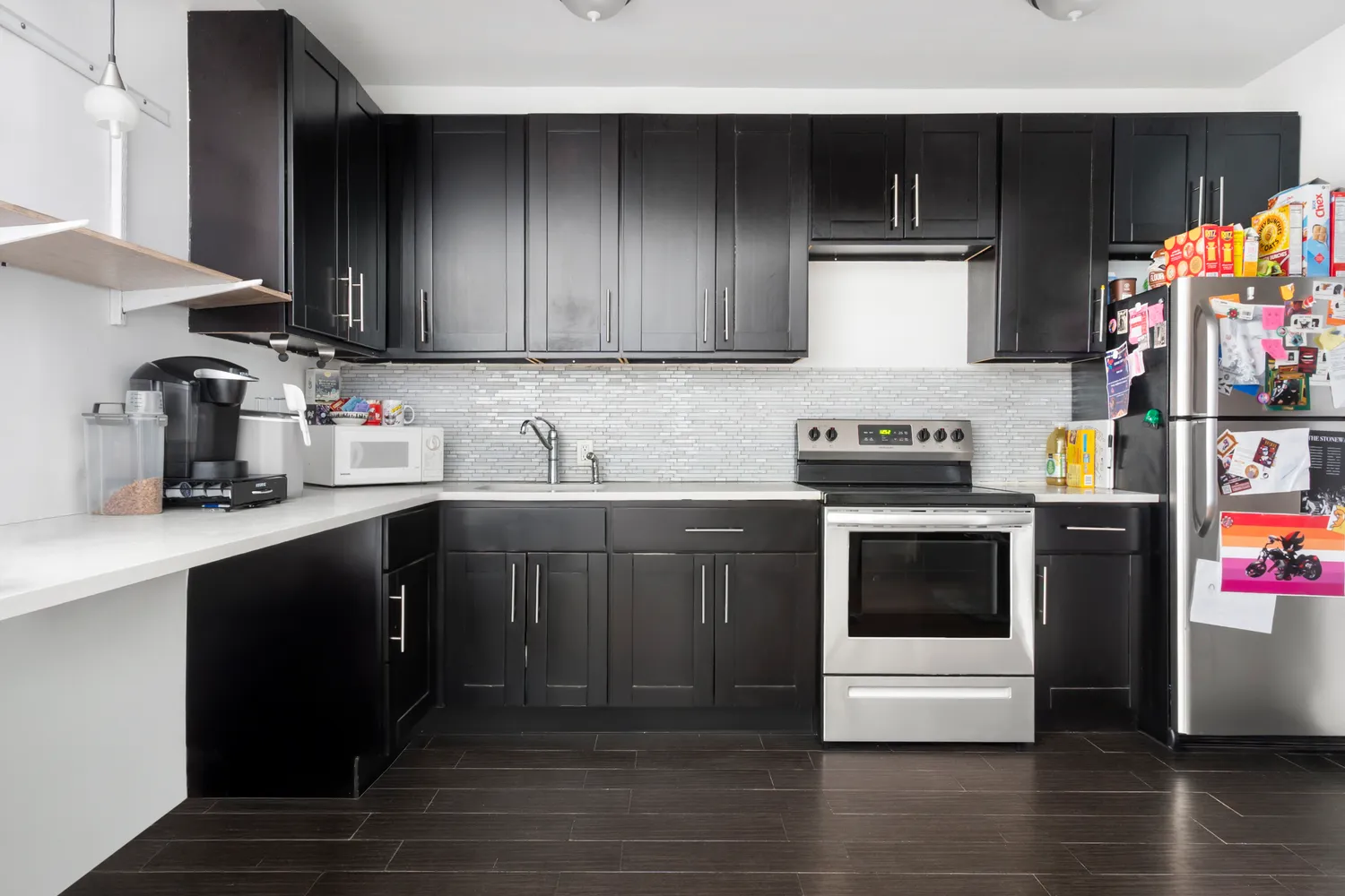 a kitchen with stainless steel appliances granite countertop a refrigerator and a stove top oven