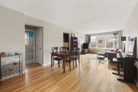 a living room with furniture dining table and wooden floor