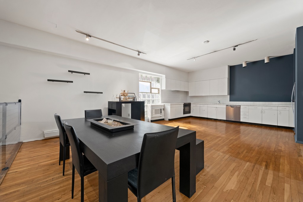 13 Worth Street, Unit 11 Manhattan, NY 10013 - Photo 6 of 9 a view of a dining room with furniture and wooden floor