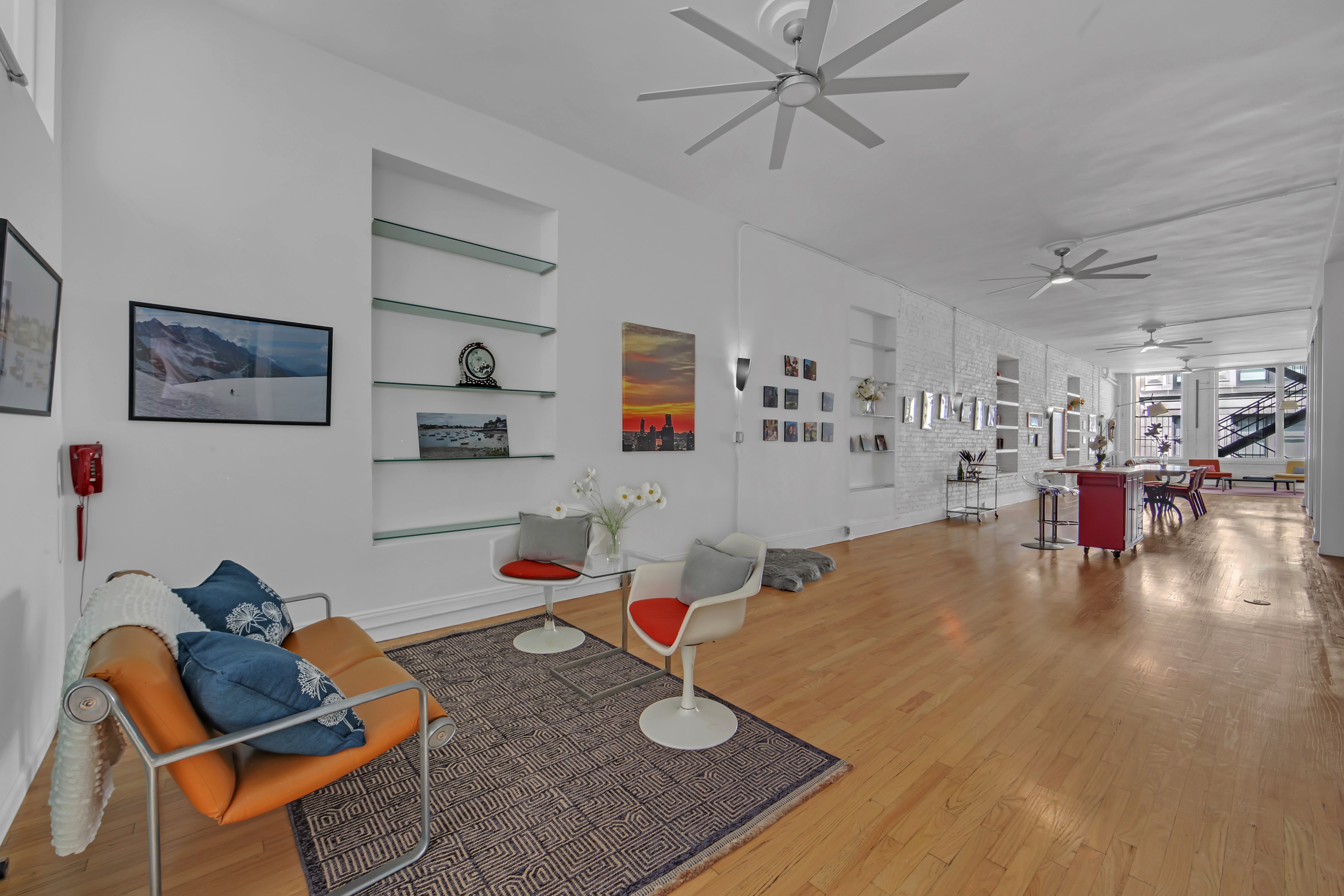 56 East 11th Street, Unit 7 Manhattan, NY 10003 - Photo 12 of 18 a living room with furniture and wooden floor