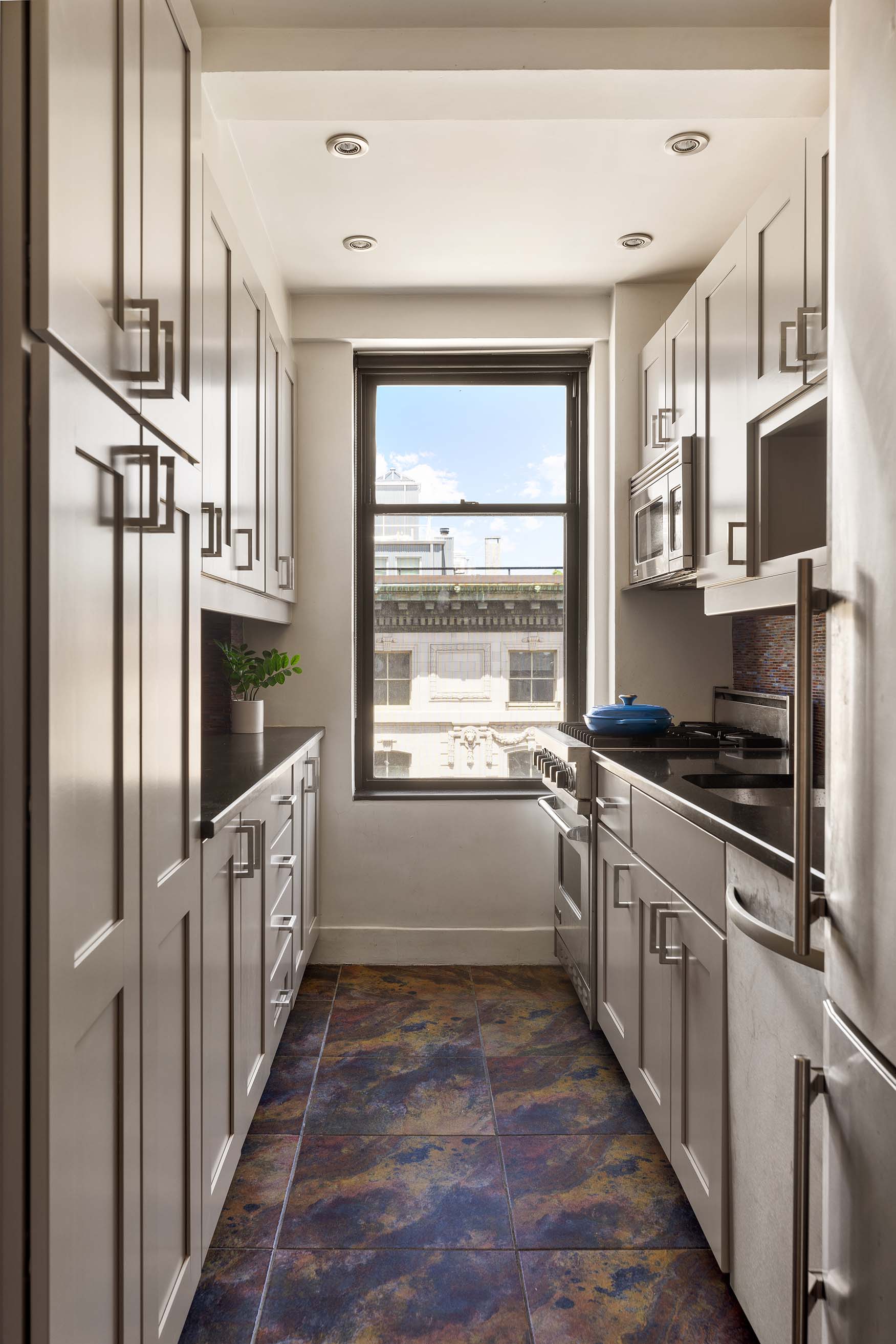 200 West 86th Street, Unit 17C Manhattan, NY 10024 - Photo 4 of 15 a kitchen with stainless steel appliances a sink stove and cabinets