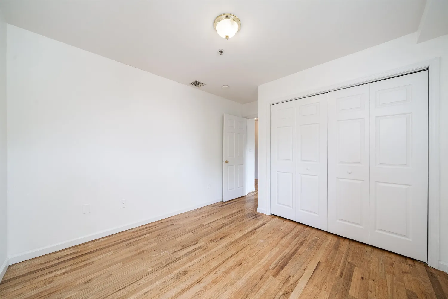 a view of room with wooden floor