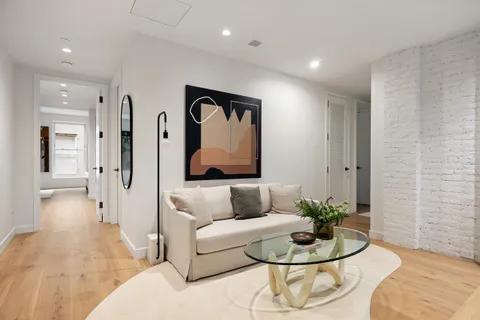 a living room with furniture and a potted plant