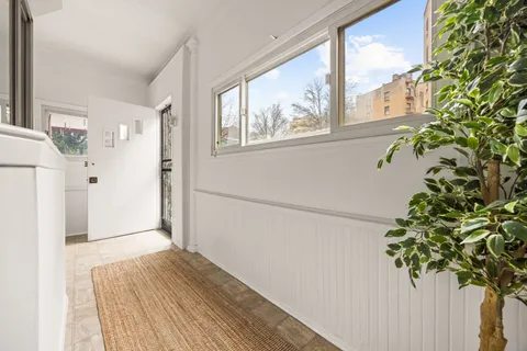 a view of entryway with wooden floor and front door