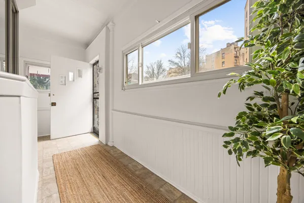 a view of entryway with wooden floor and front door