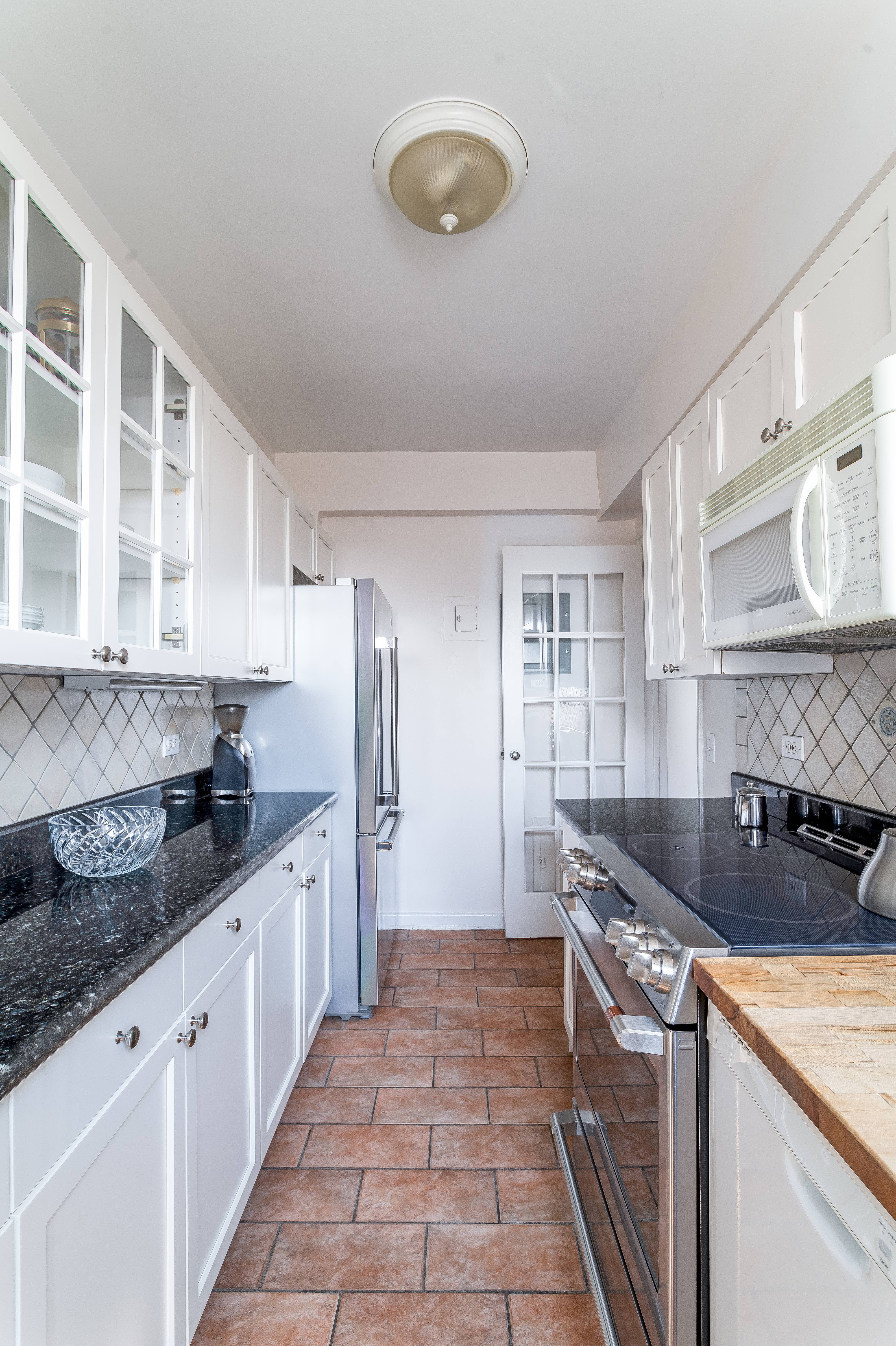 140 Cabrini Boulevard, Unit 136 Manhattan, NY 10033 - Photo 9 of 33 a kitchen with granite countertop a sink and cabinets