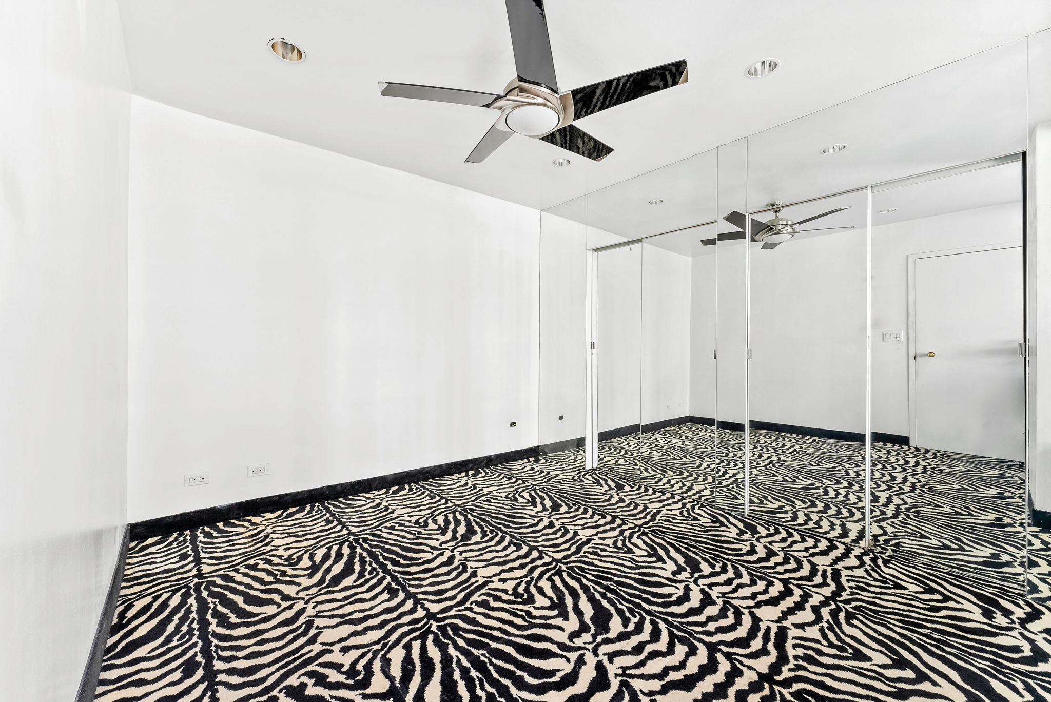 40 Sutton Place, Unit 10M Manhattan, NY 10022 - Photo 7 of 10 a view of a room with a black and white wall