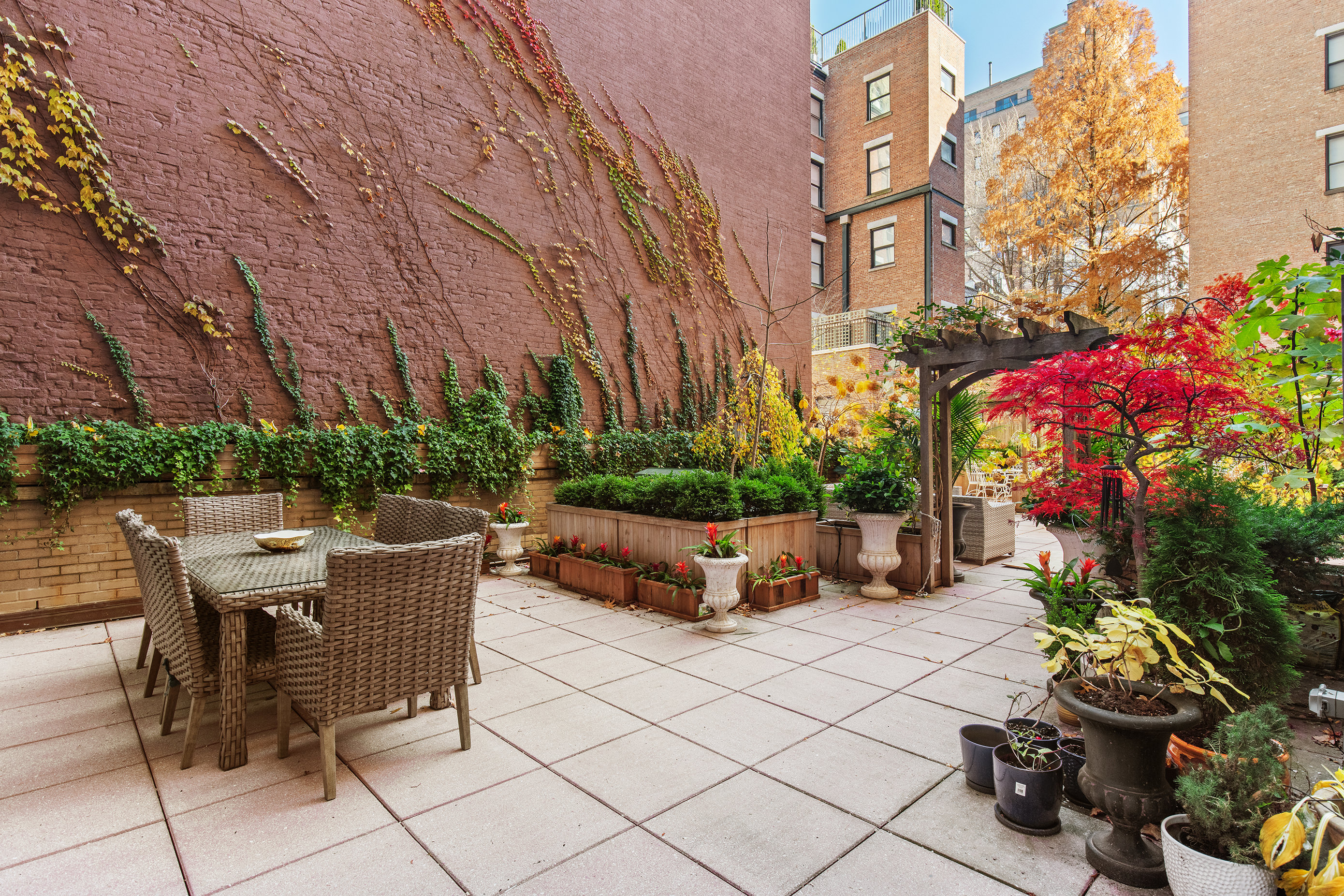 923 5th Avenue, Unit 2A Manhattan, NY 10021 - Photo 13 of 14 a view of a patio with table and chairs and potted plants